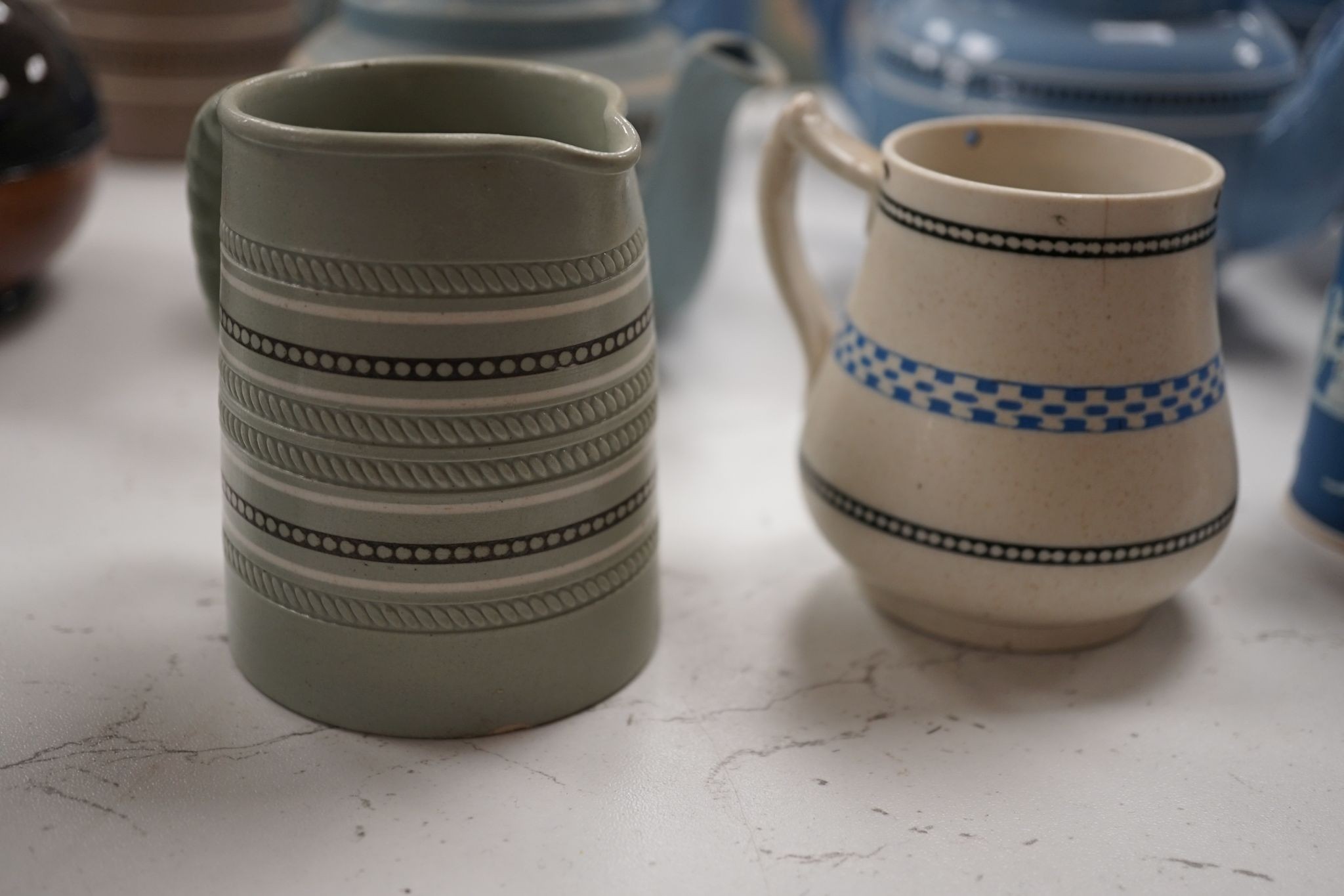 A collection of Dudson stoneware, including jugs, teapots, cream jugs etc, many decorated in low relief